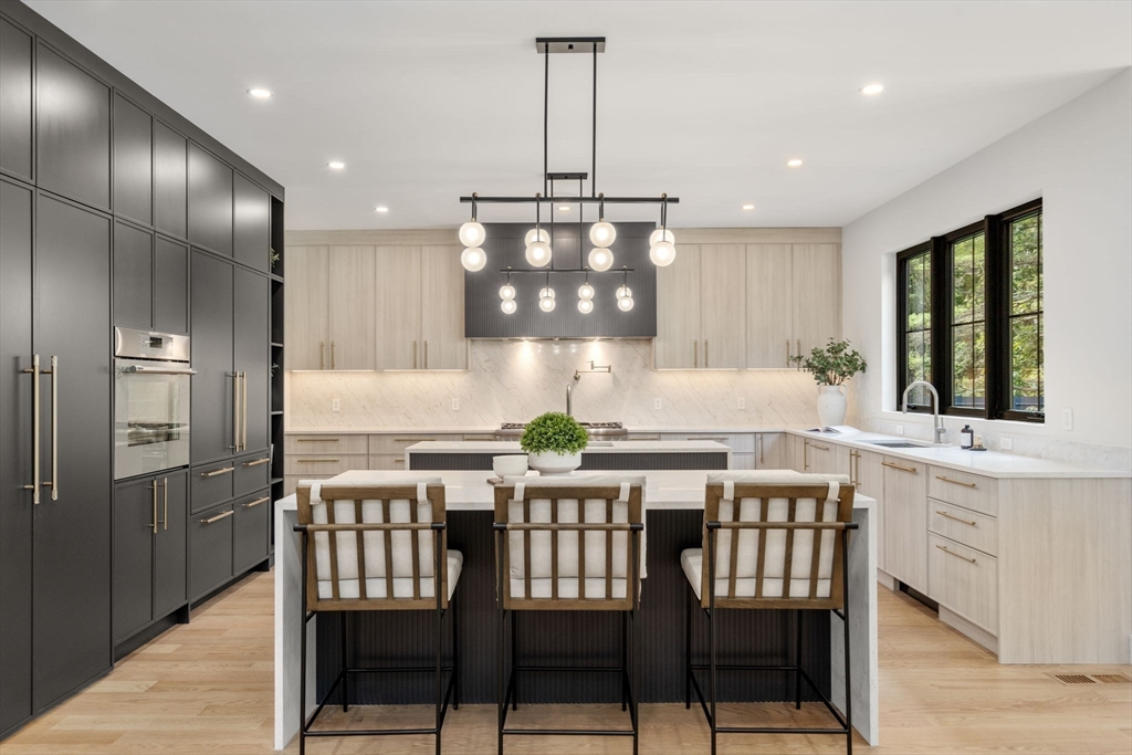 68 Locust Lane Needham, MA 02492 - Photo 9 of 39 a kitchen with a dining table chairs and refrigerator