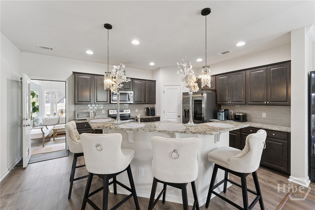 217 Gazelle Lane Pooler, GA 31322 - Photo 7 of 20 Kitchen w/ Granite Countertops & High-Top Bar