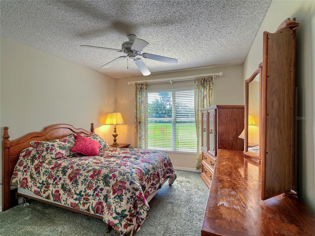 11228 Windrush Circle Hudson, FL 34667 - Photo 25 of 67 a bedroom with a large bed and a window