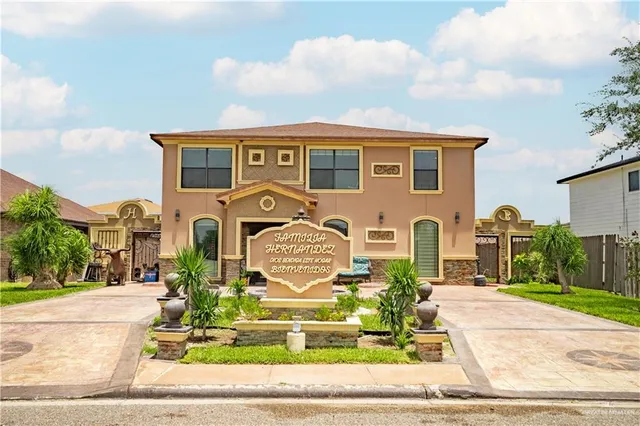 a front view of a house with garden
