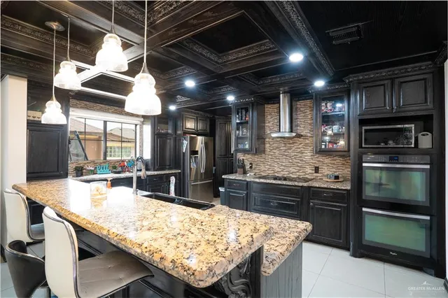 a kitchen with stainless steel appliances granite countertop a sink and wooden cabinets