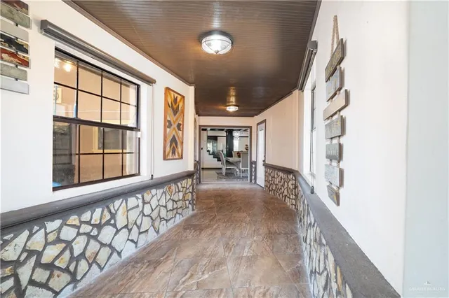 a view of a hallway with wooden floor and entryway