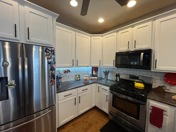 a kitchen with a sink appliances and cabinets