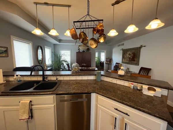 a kitchen with a sink a counter space and cabinets