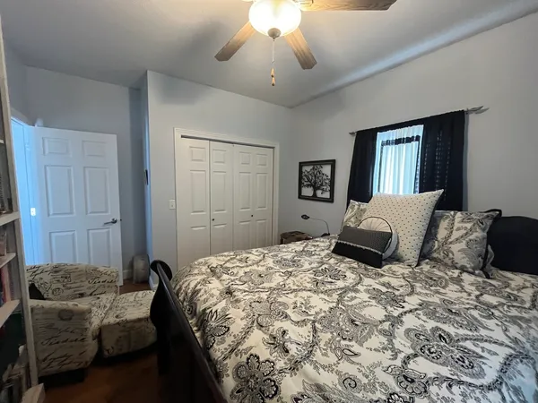 a bedroom with a bed and a chandelier