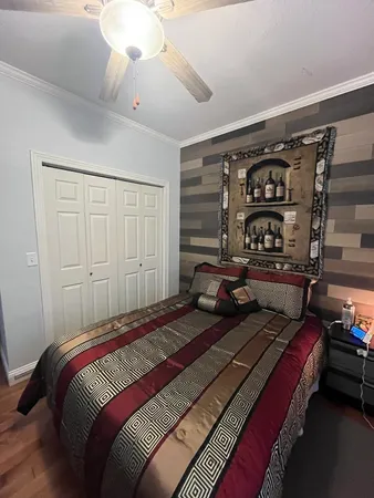 a bedroom with a bed window and walk in closet