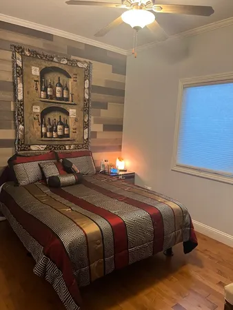 a bedroom with bed and a window