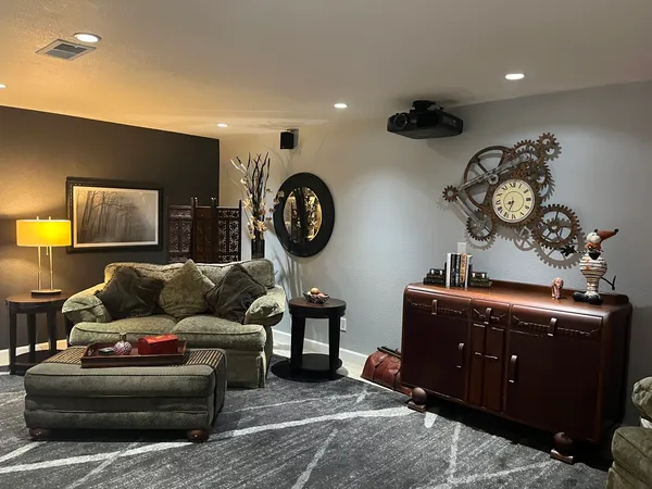 a living room with furniture and a mirror