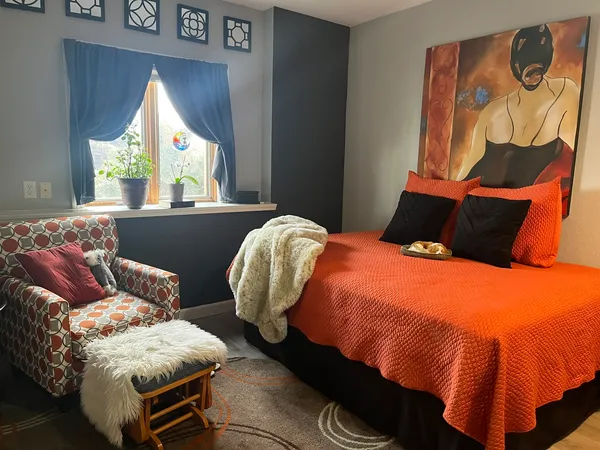 a bedroom with a bed and window