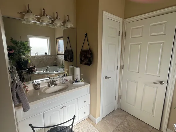 a bathroom with a sink a mirror and shower