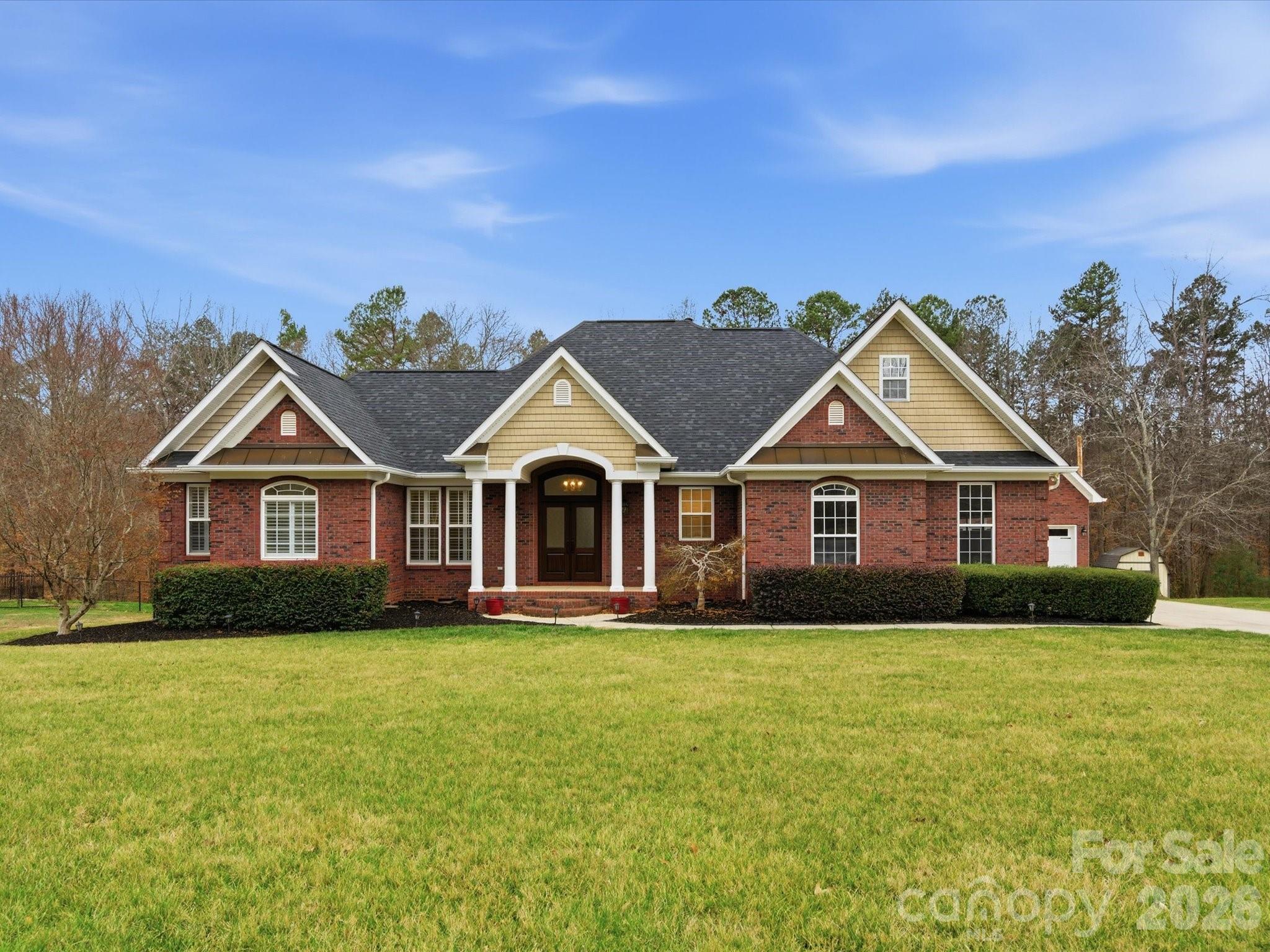 a front view of house with yard and green space