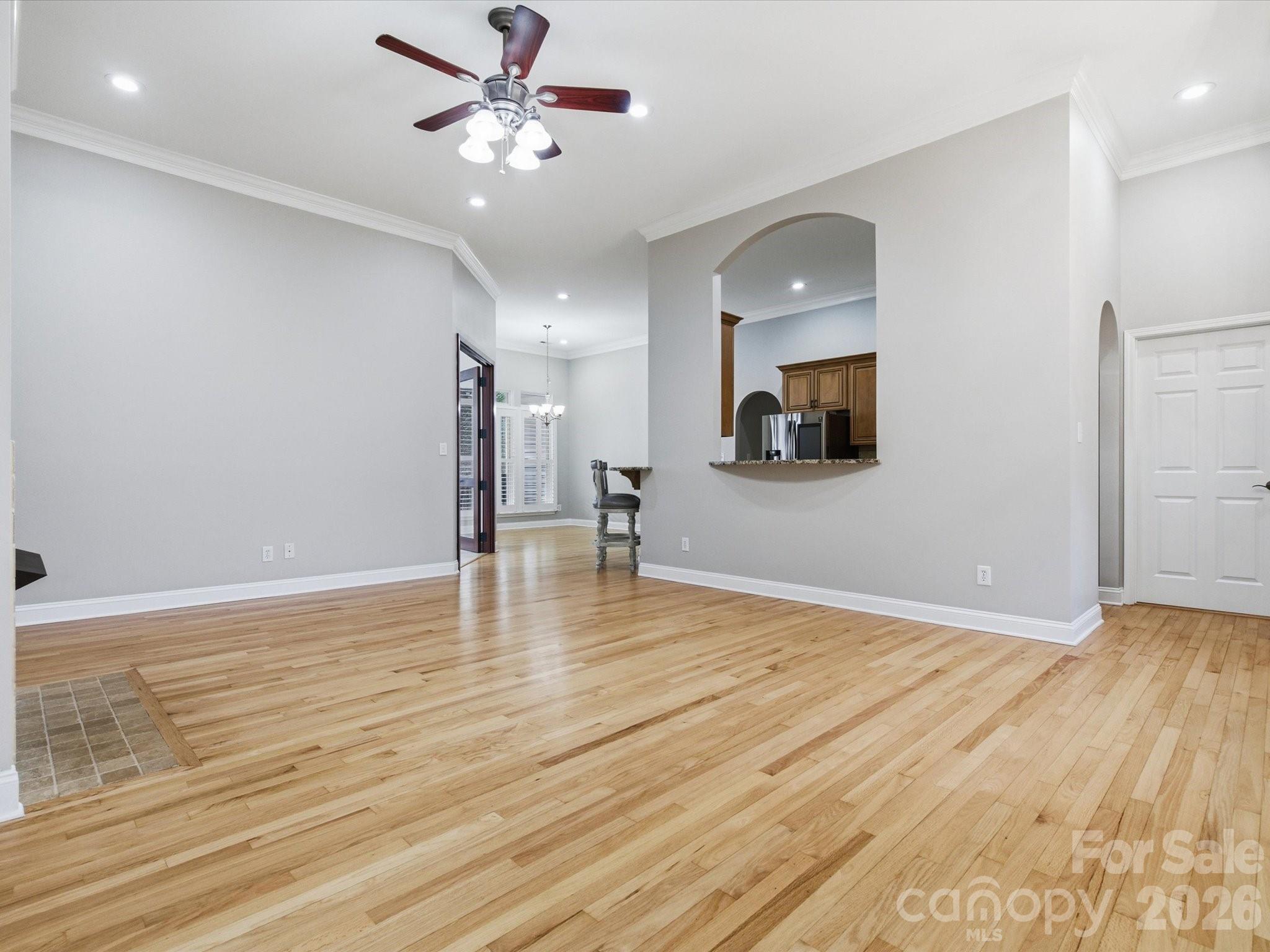 117 Abernathy Road Stanley, NC 28164 - Photo 18 of 47 a view of a room with wooden floor and a ceiling fan