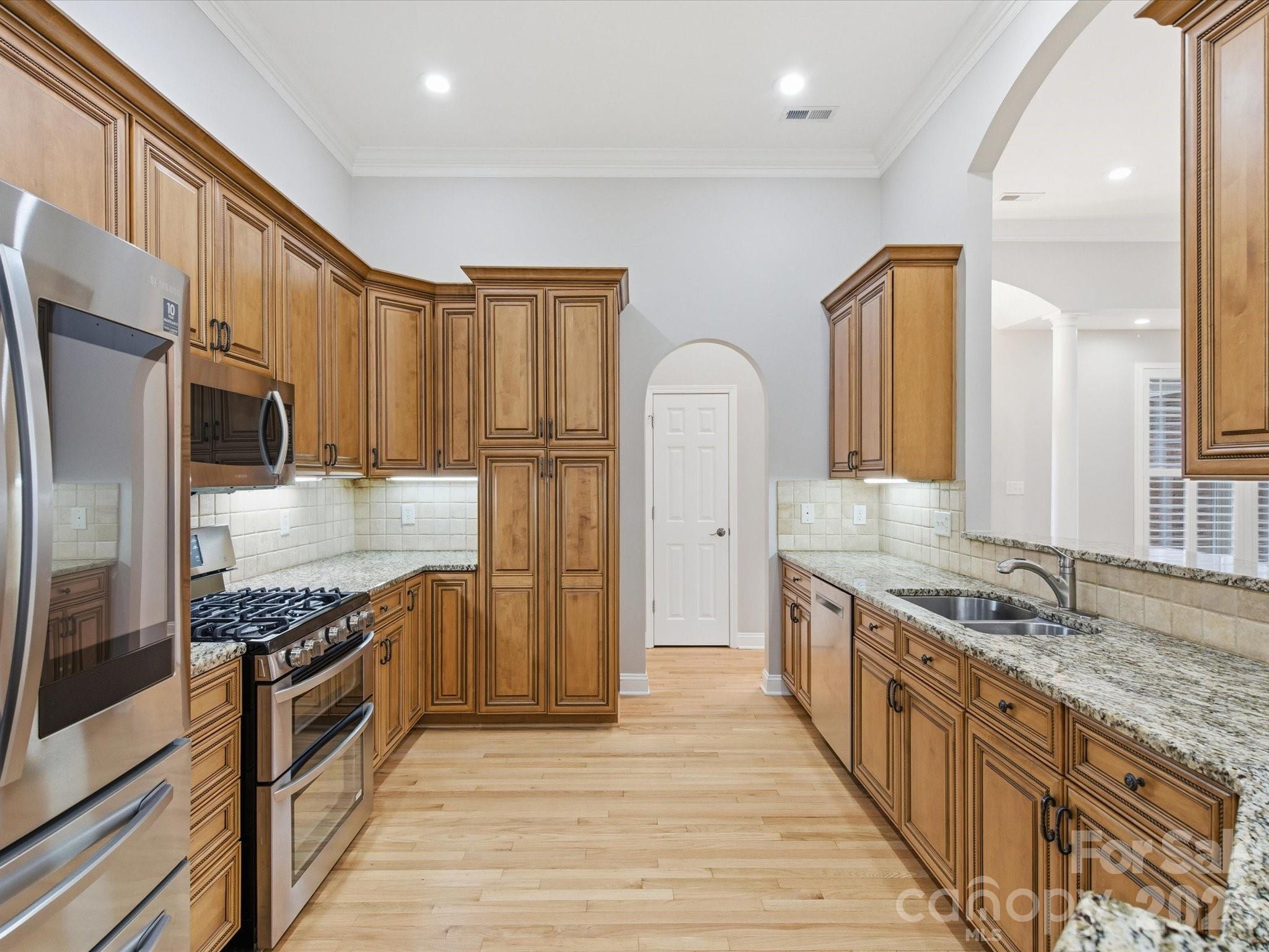 117 Abernathy Road Stanley, NC 28164 - Photo 23 of 47 a kitchen with stainless steel appliances granite countertop a stove a sink and a refrigerator