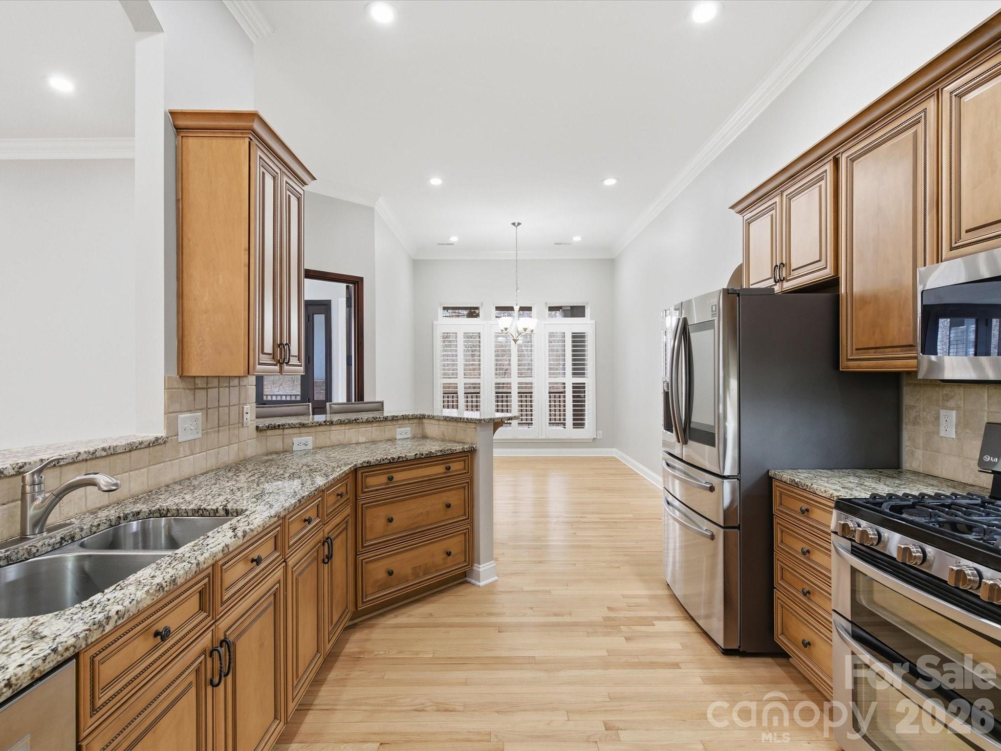 117 Abernathy Road Stanley, NC 28164 - Photo 24 of 47 a kitchen with stainless steel appliances granite countertop a sink stove and refrigerator