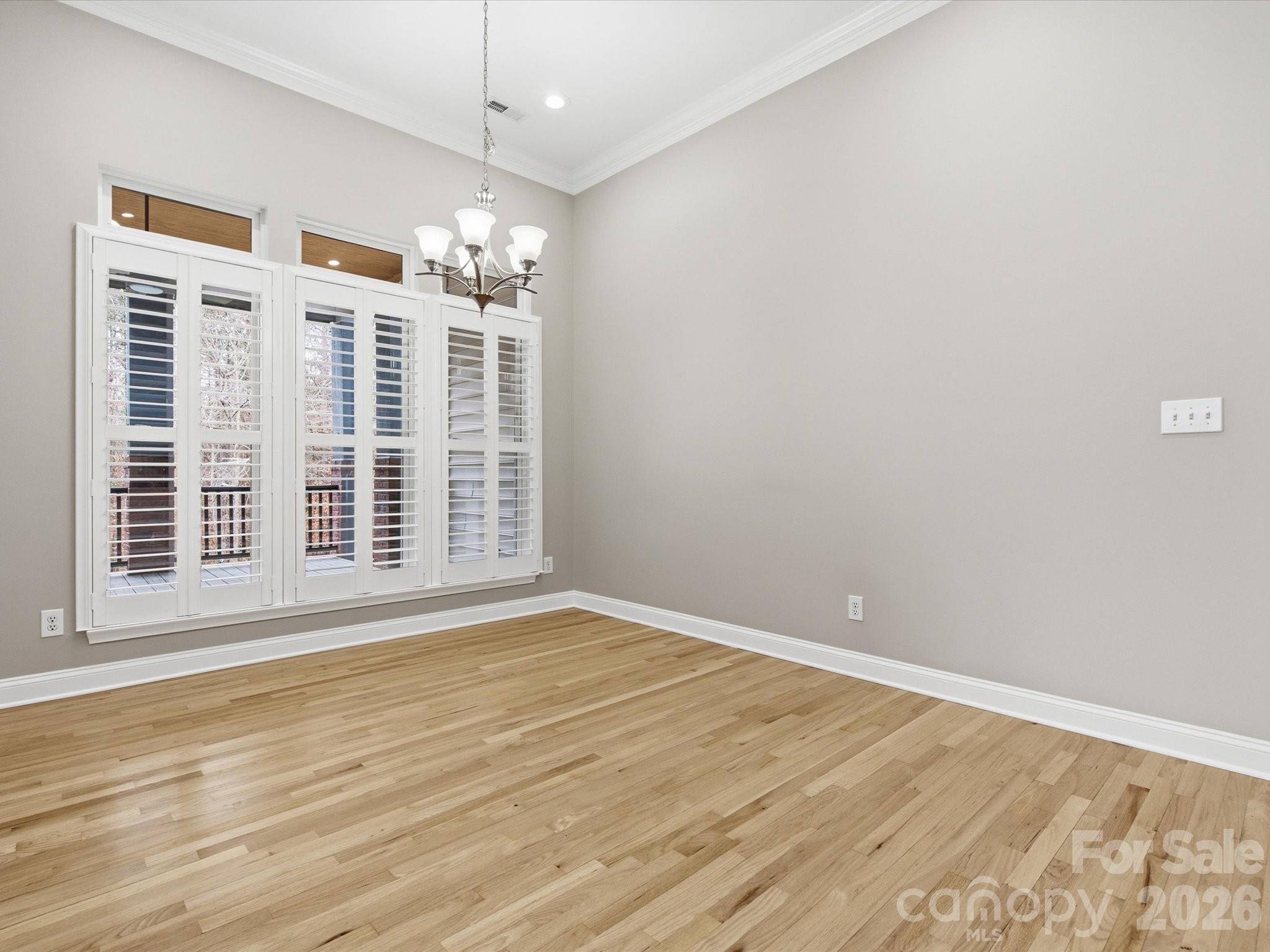 117 Abernathy Road Stanley, NC 28164 - Photo 30 of 47 a view of an empty room with wooden floor and a window