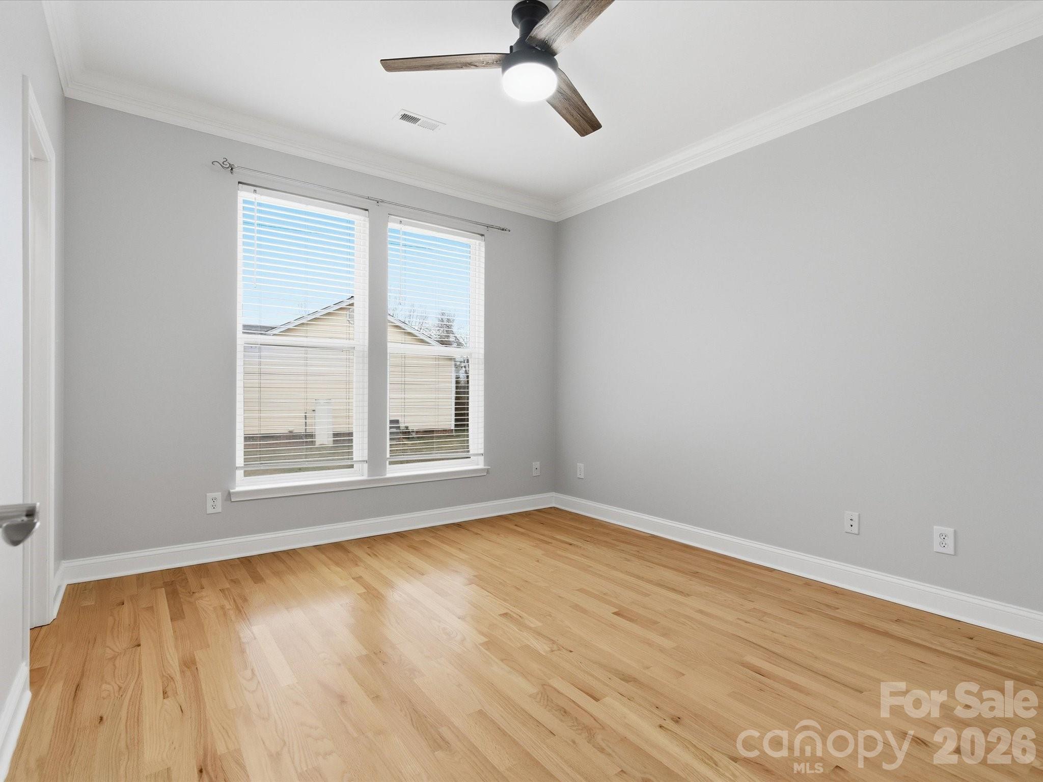 117 Abernathy Road Stanley, NC 28164 - Photo 43 of 47 a view of an empty room with wooden floor and a window