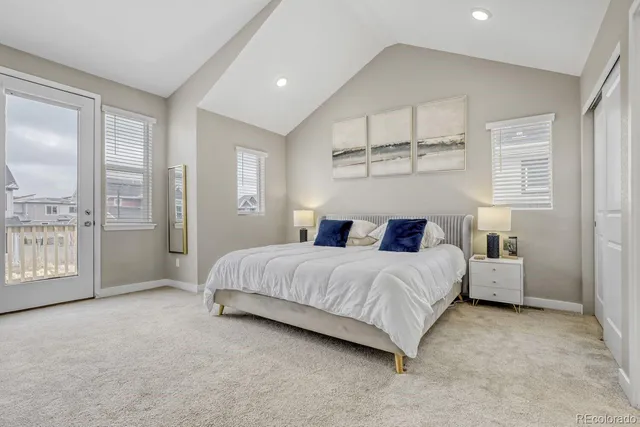 a spacious bedroom with a bed and a large window