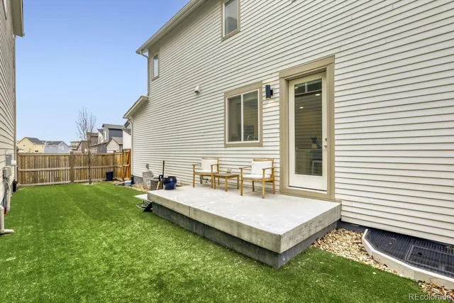 a white house sitting in the middle of a yard