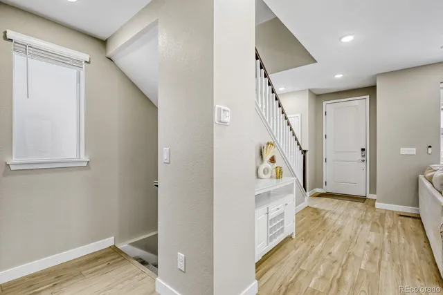 a view of an entryway with wooden floor