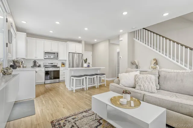 a living room kitchen with furniture and a dining table with kitchen view