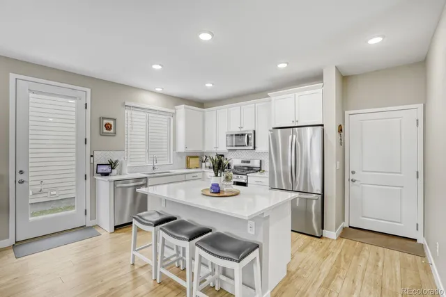a kitchen with a refrigerator a stove and a cabinets