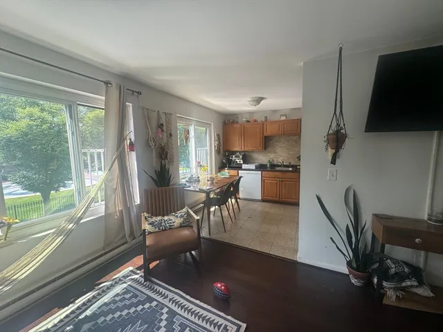 a living room with a fireplace furniture and a large window