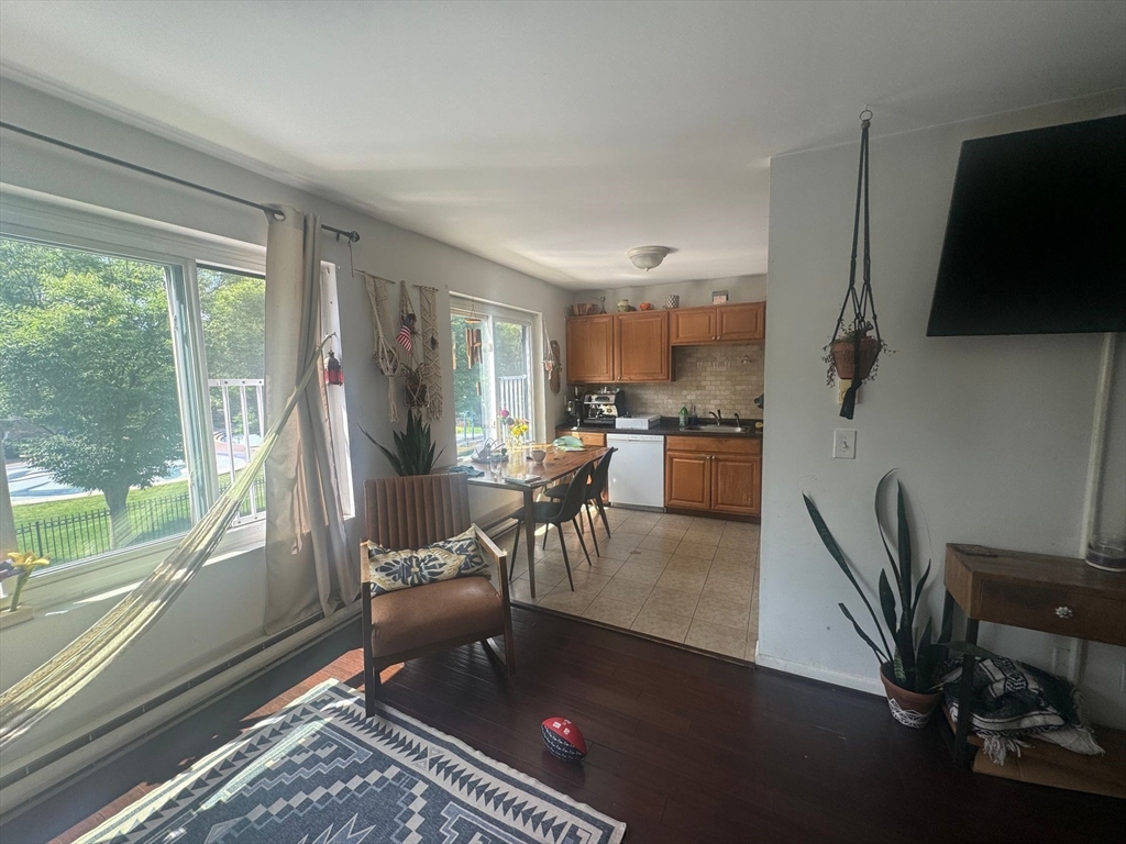 128 Marginal Street, Unit 2 Boston, MA 02128 - Photo 2 of 10 a living room with a fireplace furniture and a large window