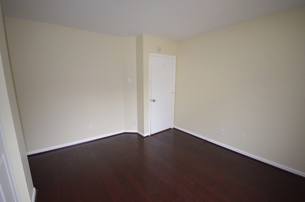128 Marginal Street, Unit 2 Boston, MA 02128 - Photo 6 of 10 an empty room with wooden floor