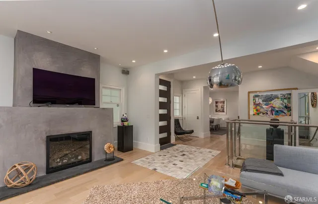 a living room with furniture a flat screen tv and a fireplace