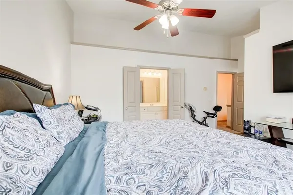 a bedroom with a bed and a chandelier