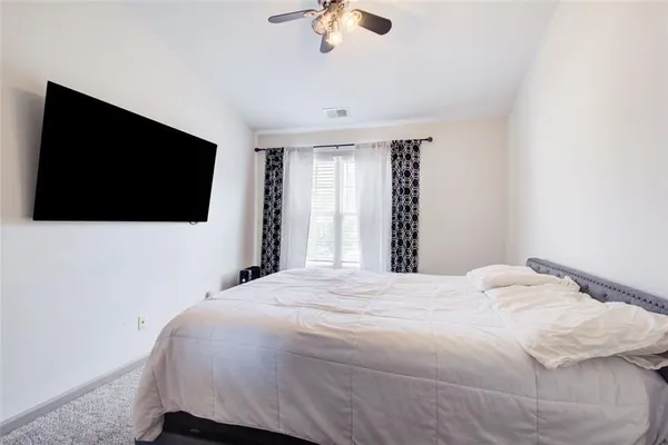 a large bed in a white room
