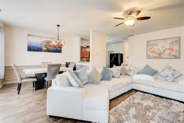 a living room with furniture and a wooden floor