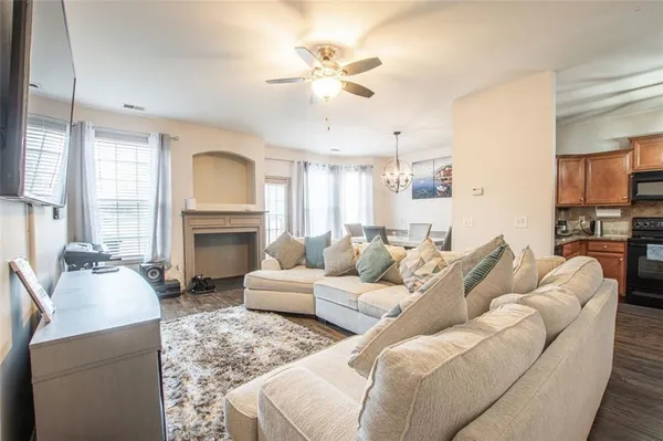 a living room with furniture fireplace and a chandelier