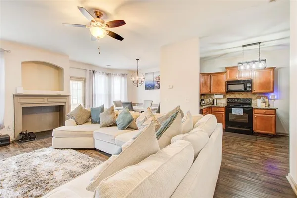 a living room with furniture kitchen view and a fireplace