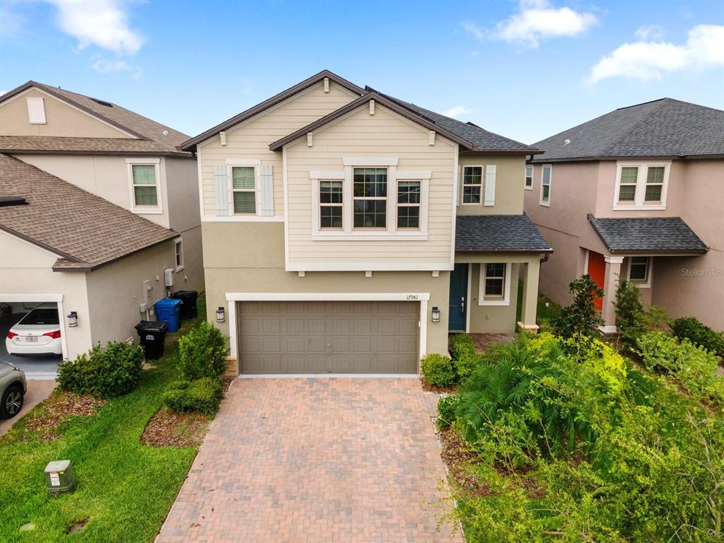 a front view of a house with a yard and garage