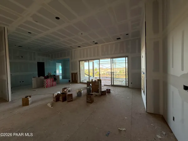 an empty room with closet and a window