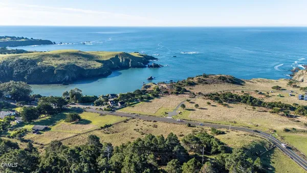 a view of a backyard with wooden fence