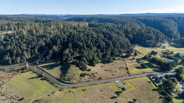 a view of a town with mountains in the background