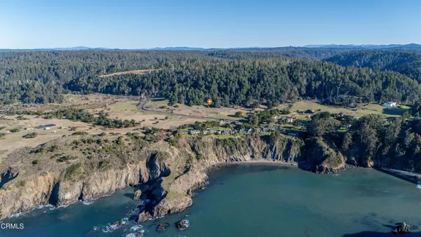 a view of a backyard with wooden fence