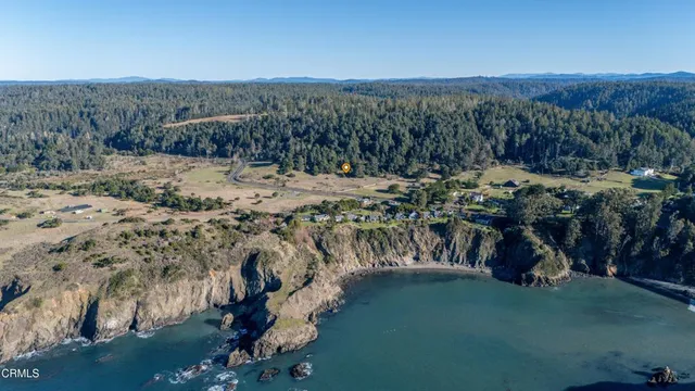 a view of a backyard with wooden fence