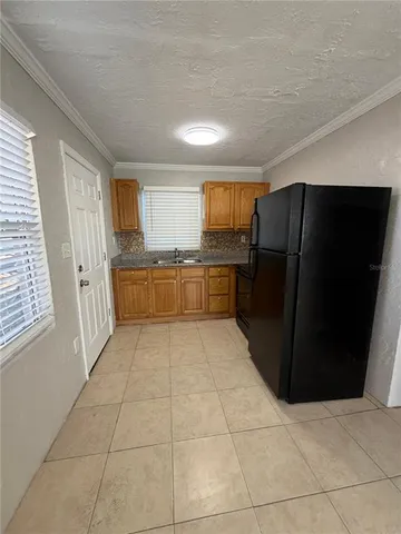 a kitchen with a refrigerator and a sink