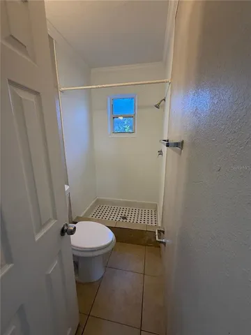 a bathroom with a toilet and a shower