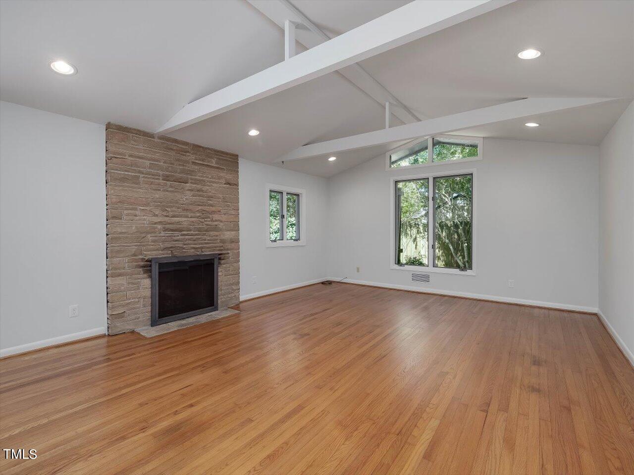 2129 Ridge Road Raleigh, NC 27607 - Photo 17 of 79 an empty room with wooden floor and windows