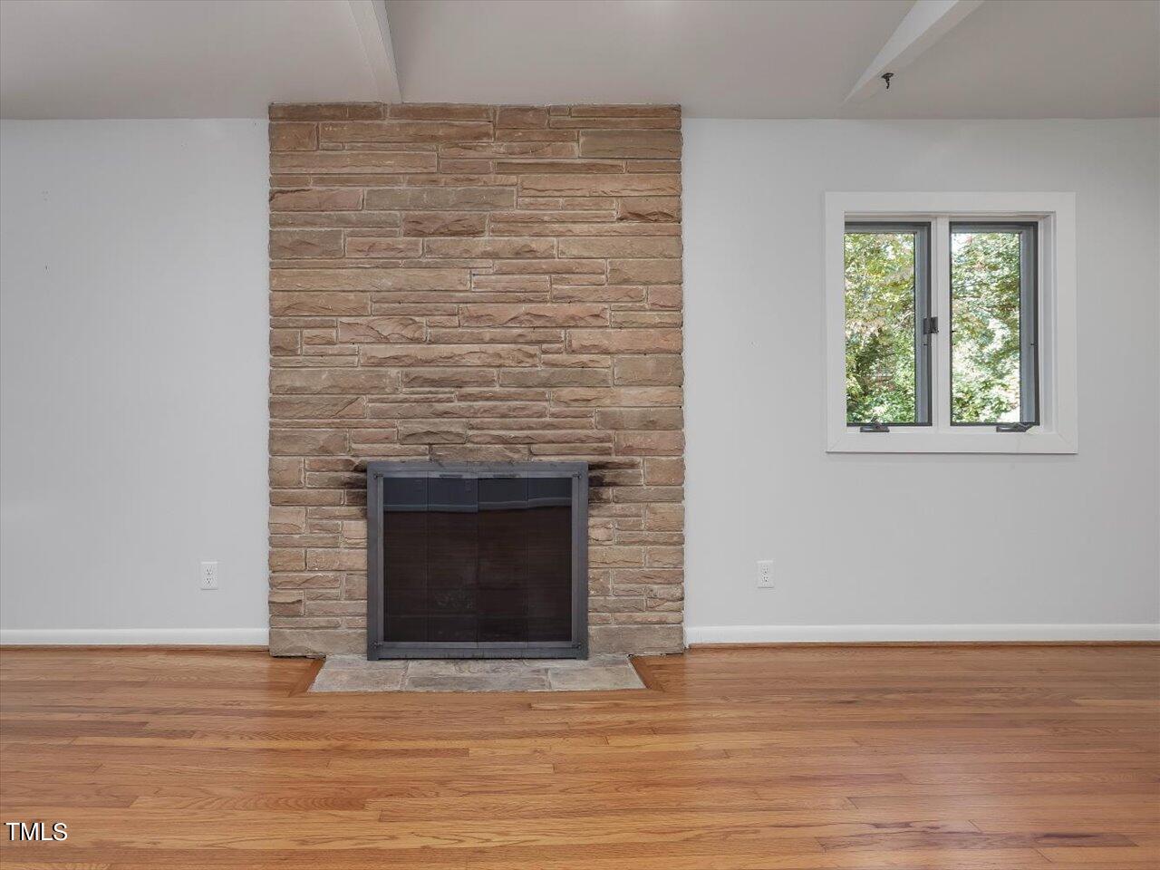 2129 Ridge Road Raleigh, NC 27607 - Photo 18 of 79 a view of empty room with wooden floor and a fireplace