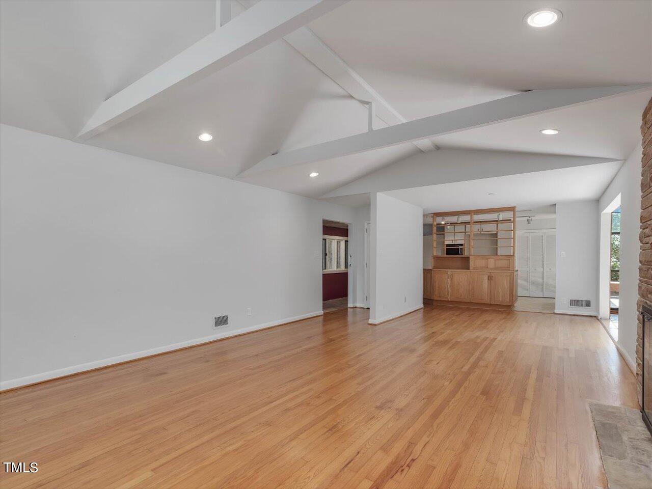 2129 Ridge Road Raleigh, NC 27607 - Photo 20 of 79 an empty room with wooden floor and windows