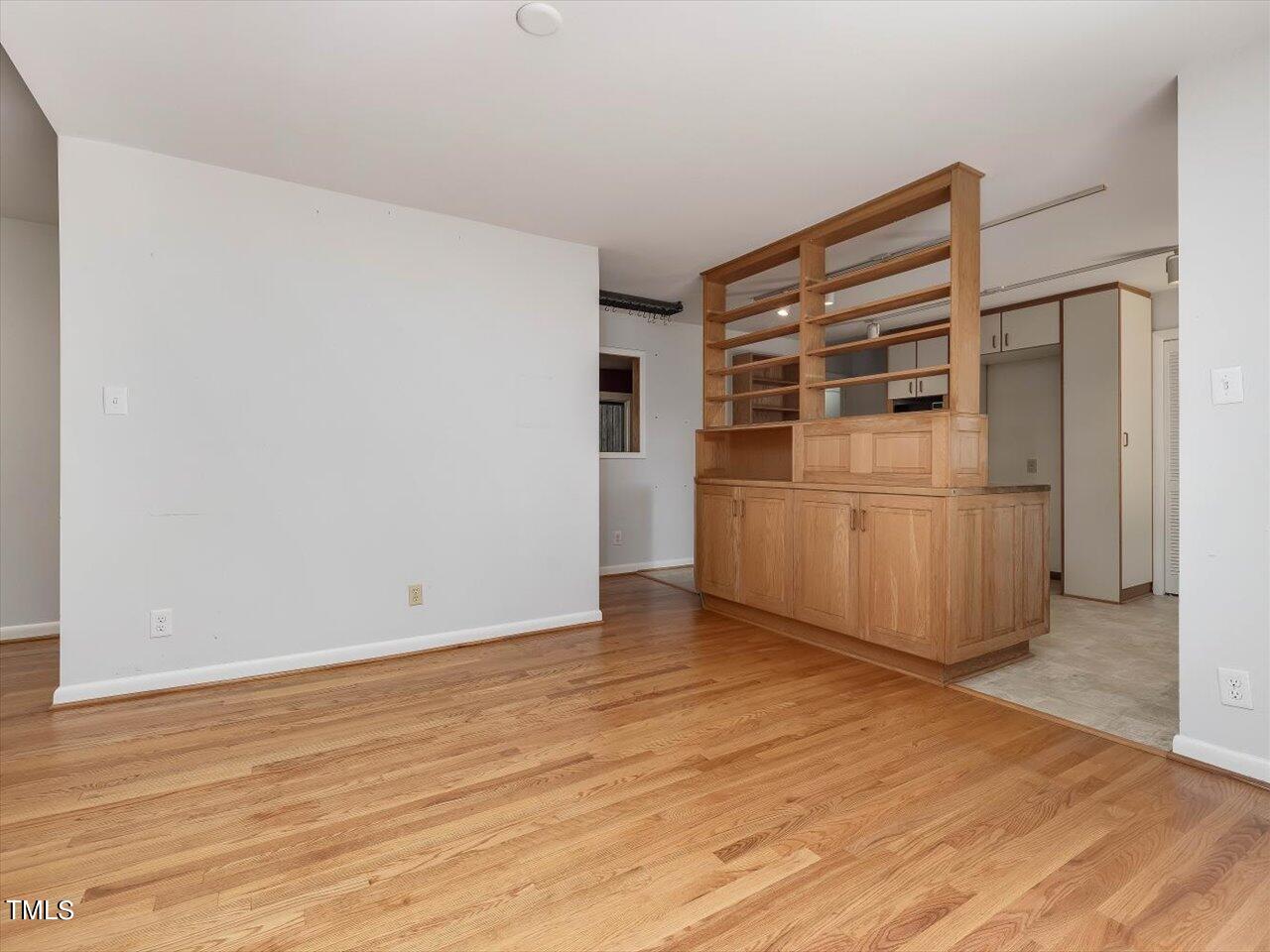 2129 Ridge Road Raleigh, NC 27607 - Photo 26 of 79 a view of an empty room with wooden floor and cabinets