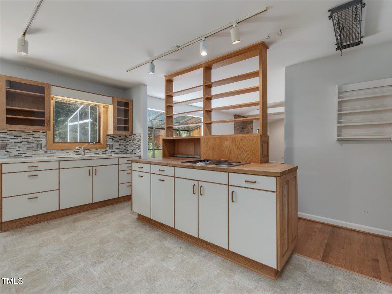 2129 Ridge Road Raleigh, NC 27607 - Photo 29 of 79 a kitchen with granite countertop white cabinets a sink a window and stainless steel appliances