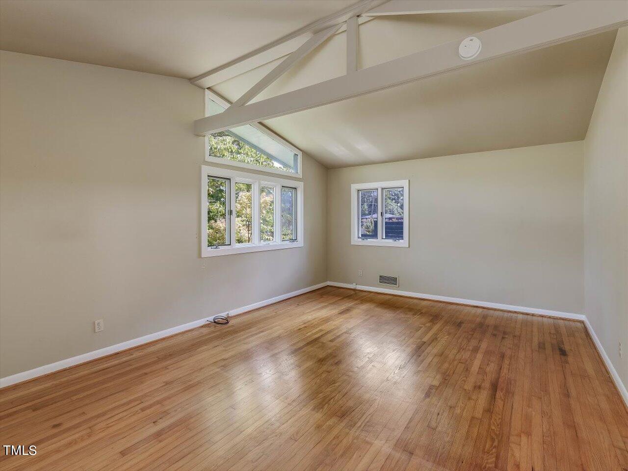 2129 Ridge Road Raleigh, NC 27607 - Photo 48 of 79 an empty room with wooden floor and windows