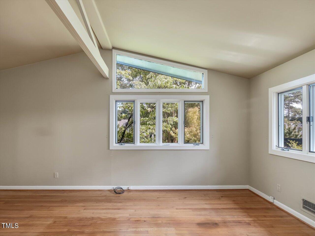 2129 Ridge Road Raleigh, NC 27607 - Photo 49 of 79 an empty room with wooden floor and windows
