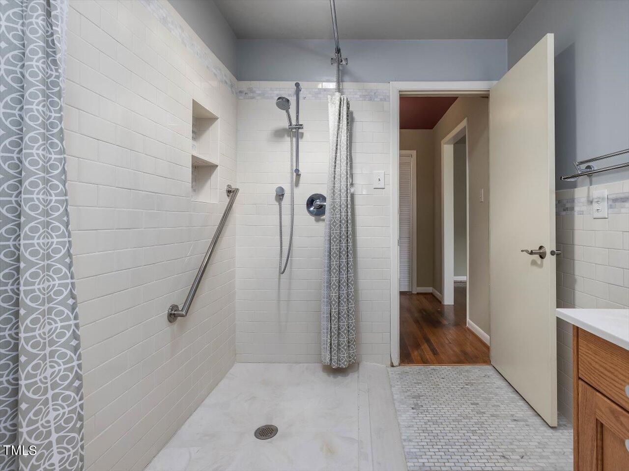 2129 Ridge Road Raleigh, NC 27607 - Photo 53 of 79 a view of a bathroom with a tub and shower